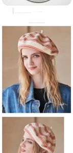 Detail of a beige knitted wool beret with red stripes paired with a blue denim jacket