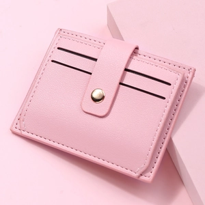 Detail of pink PU leather card holder showing soft texture and gold snap closure