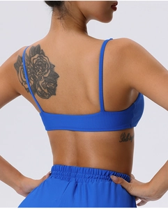 Detailed back view of royal blue ribbed sports bra with thin straps and open back design
