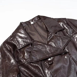 Detailaufnahme der dunkelbraunen PU-Lederjacke mit Hochglanzoberfläche und Doppelreiher-Knöpfen