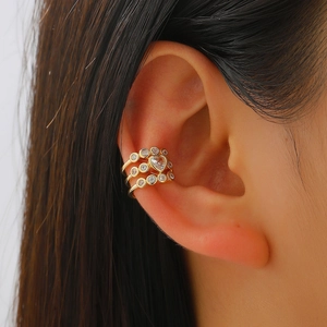 Detail of a gold-plated multi-layer ear cuff featuring heart-shaped zircon and micro-inlay