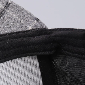 Macro shot of houndstooth wool fabric stitching and inner sweatband on baseball cap