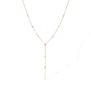 Detail view of a gold Y-shaped chain necklace with small teardrop pendants on white background