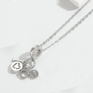 Macro shot of silver pendant with I Heart U letters and paved crystals on a fine chain