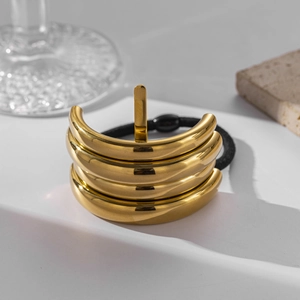 Detail of multi-layer gold stainless steel hair cuff with high elastic black hair tie