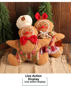 Close-up of plush gingerbread man and girl dolls with festive plaid outfits and embroidery