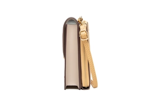 Side view detail of beige and brown leather shoulder bag with adjustable strap and zip