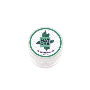 Macro view of 5g matcha lash extension glue remover paste in a clear jar with green leaf label