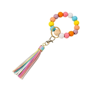 Colorful beaded keychain wristlet with wooden bead and leather tassel on white background
