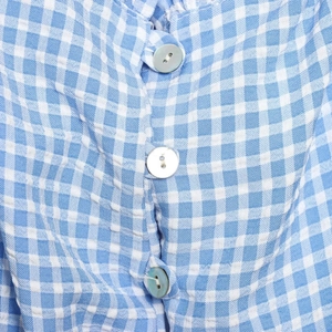 Women's blue and white checkered plaid shirt with white round buttons and knot detail