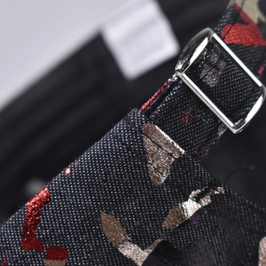 Macro view of adjustable silver metal buckle and red metallic gold foil print on cap strap