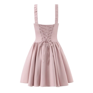 Detail view of the pink dress featuring an elegant corset lace-up back design