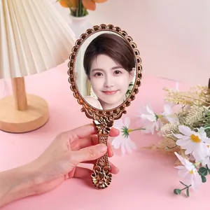 Vintage gold embossed handheld vanity mirror with elegant European style floral frame