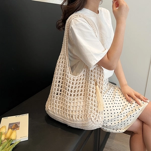 Chic cream crochet knit tote bag with mesh design and long tassels for summer beach style