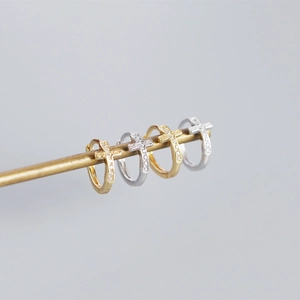 Detail of S925 sterling silver cross hoop earrings with cubic zirconia micro-inlay finish