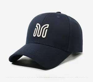 Close-up side view of a navy blue cotton baseball cap with white embroidered M logo