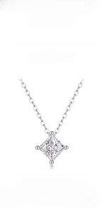 Macro shot of 925 sterling silver necklace featuring a square cut moissanite in four-prong setting