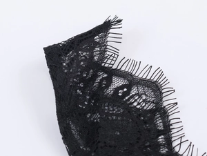 Detailed close-up of high-quality black lace fabric with delicate eyelash trim edges