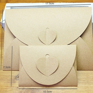 Vintage kraft paper heart-clasp envelopes in two sizes on a natural wood surface