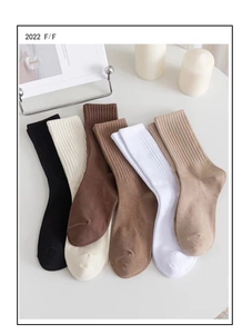 Flat lay of six pairs of ribbed mid-calf socks in earthy tones like mocha and beige