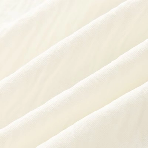 Close-up of beige fabric texture and natural soft folds for this summer outfit set