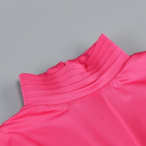 Detail of rose red high-neck top with fine pleated texture and hidden zipper closure