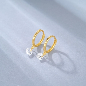 Detailed close-up of a gold-plated hoop earring featuring a square-cut sparkling zircon