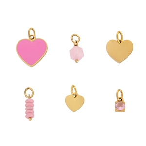 Detail of six gold pendants with pink enamel hearts and crystal charms for DIY jewelry