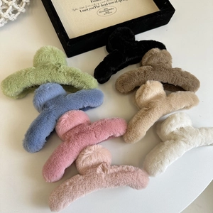 Set of eight plush faux fur hair claw clips in various soft pastel colors for women