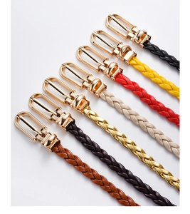 Detail view of woven belts in seven vibrant colors with elegant gold metal buckles