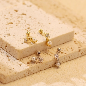 Macro shot of elegant S925 silver pearl earrings with zircon in gold and silver finish