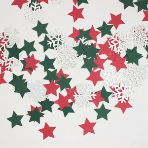 Flat lay of red and green stars with glitter silver snowflakes for Christmas DIY decor