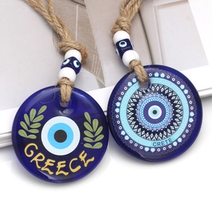 Detailed blue glass Evil Eye charms with GREECE and CRETE text on decorative jute rope