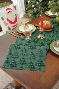 Detail of green Christmas table runner with 3D embroidery on a festive wooden table