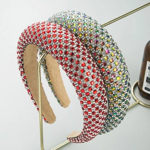 Detail of luxury padded headbands featuring dense rhinestones on gold metal stands