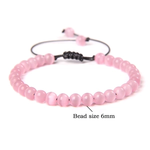 Detail of 6mm pink translucent stone beads on adjustable black woven cord bracelet