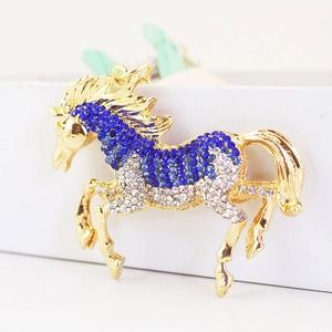 Golden horse keychain pendant with blue and white rhinestones on a metal racehorse design