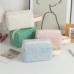 Quilted tweed makeup bag set with top handle and zipper closure for travel and storage