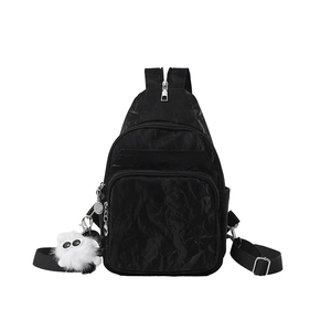 Versatile black pleated nylon chest bag with multiple pockets and plush pendant