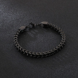 Detailed close-up of all-black stainless steel Franco chain bracelet with lobster clasp
