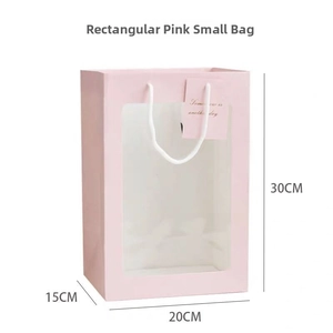 Pink gift bag with transparent window, white rope handles, and 30x20x15cm dimensions