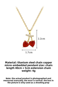 Detailed view of red heart zircon cherry pendant with micro-set diamonds and gold chain