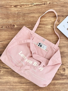 Pink canvas tote bag with letter print and internal zipper pocket for phone storage