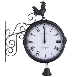 Detail of vintage iron wall clock with roman numerals, rooster crest, and hanging bell charm