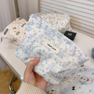 Detail of blue cartoon cotton makeup bags with zippers and simple wish labels