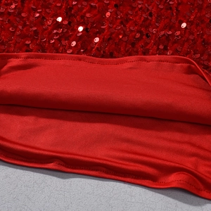 Vue macro de paillettes rouges métalliques et doublure sur cette robe scintillante