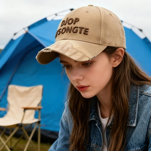Distressed khaki baseball cap with 3D embroidery shown in an outdoor camping setting
