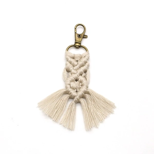 Handmade beige braided cotton rope keychain with bronze metal clip and tassel accent