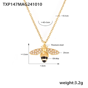 Detail view of gold bee pendant necklace with size labels and zircon stone measurements