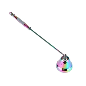 Detail of rainbow metallic bell candle snuffer showing the textured non-slip handle grip